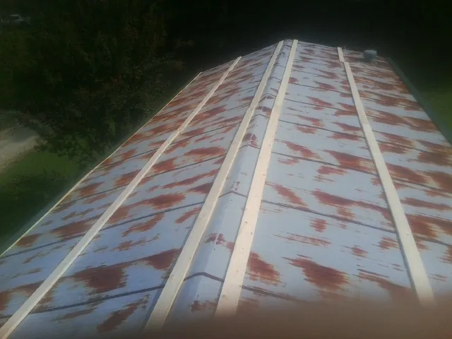 Rusted metal roof panels with new wood purlins before replacement — Storm Damage Roof Repair in Maugansville by Roofing Brothers