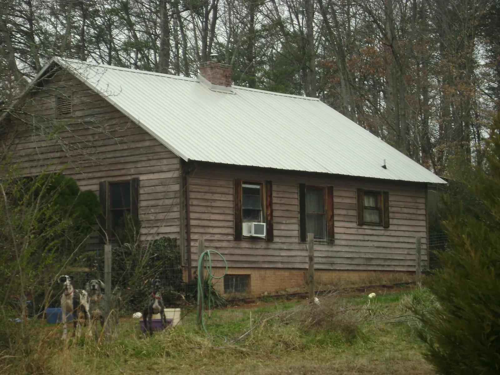 White metal roof on an old wood sided farmhouse, from a Metal Roof Installation job in Maugansville